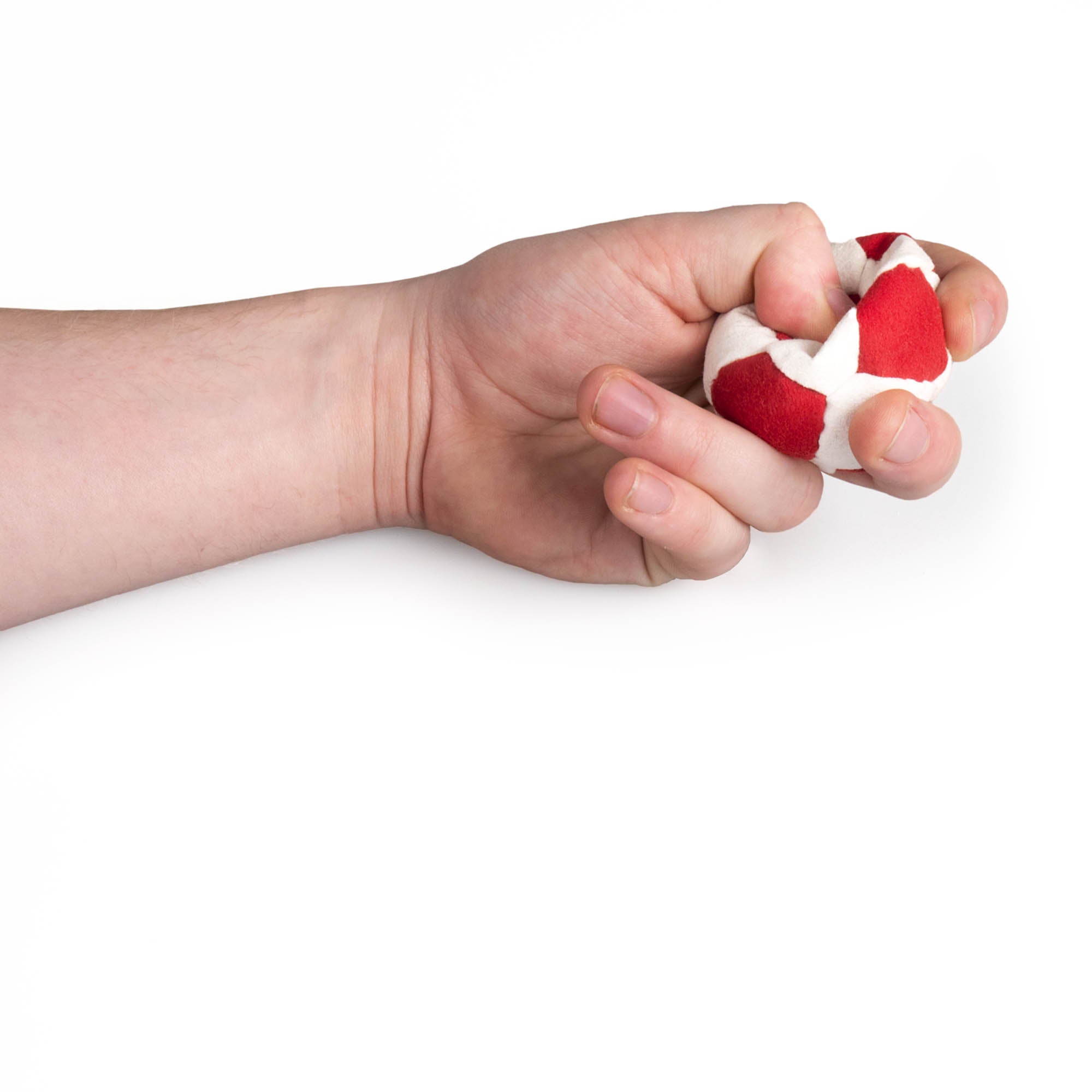 Red and white hacky sack in hand being squeezed