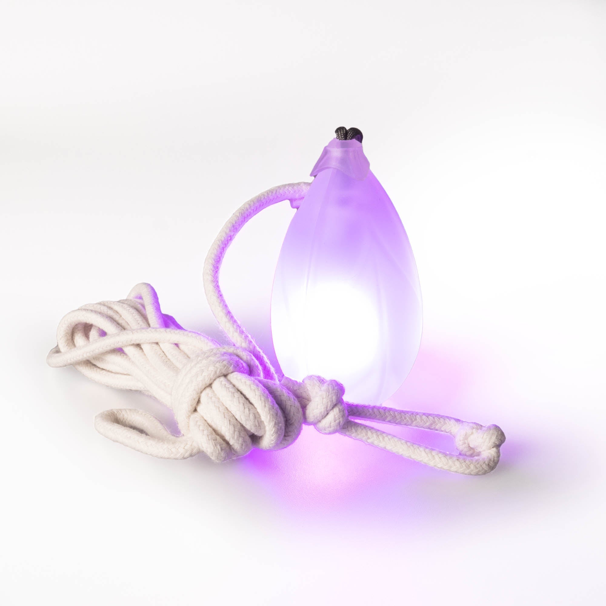 Flowtoys pod dart V2 glowing purple in a white background