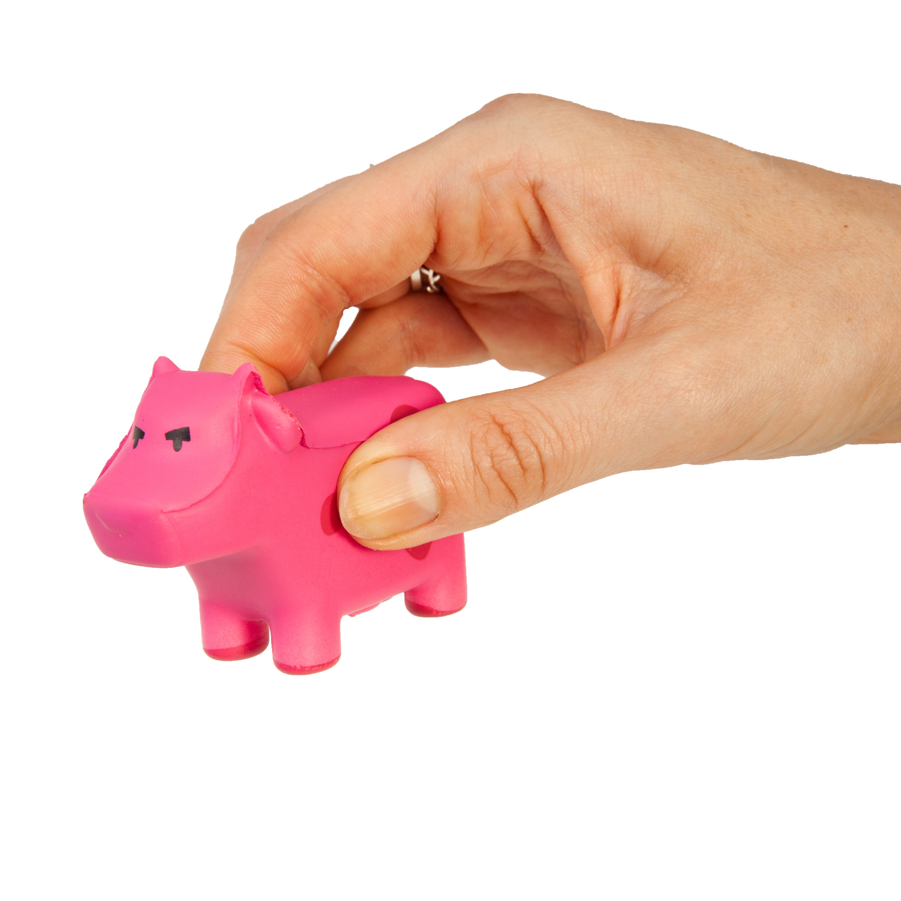 Hand holding a pink cow object against a white background