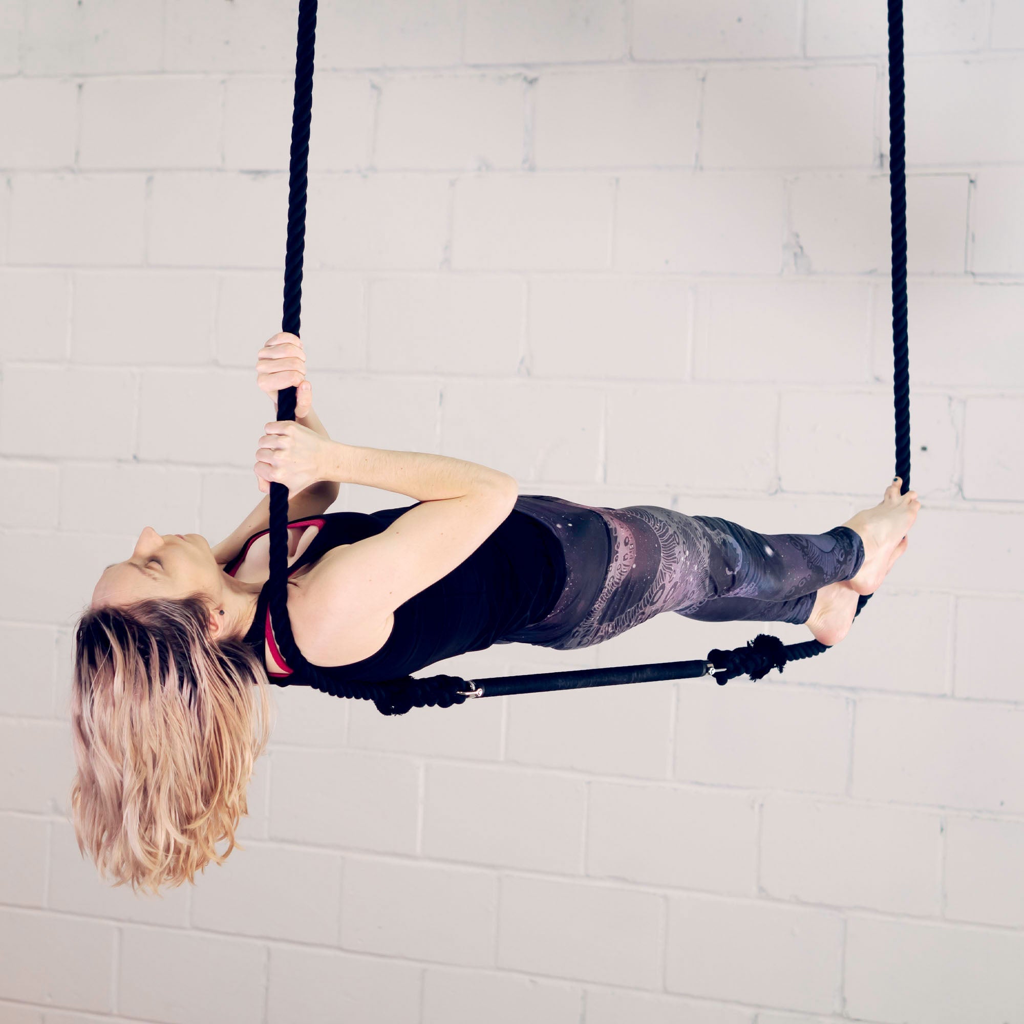 performer on shackle trapeze