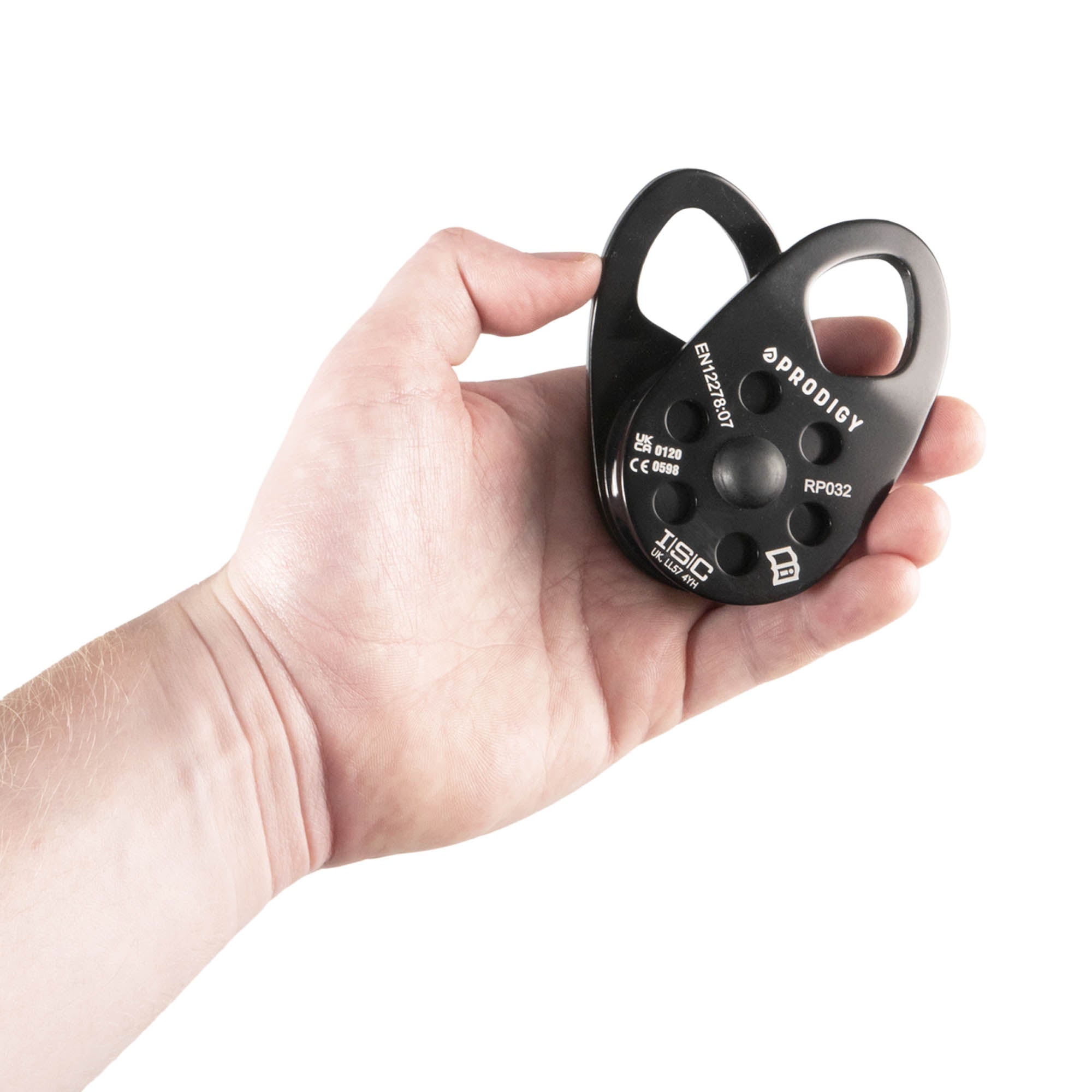 Hand holding a black Prodigy pulley against a white background