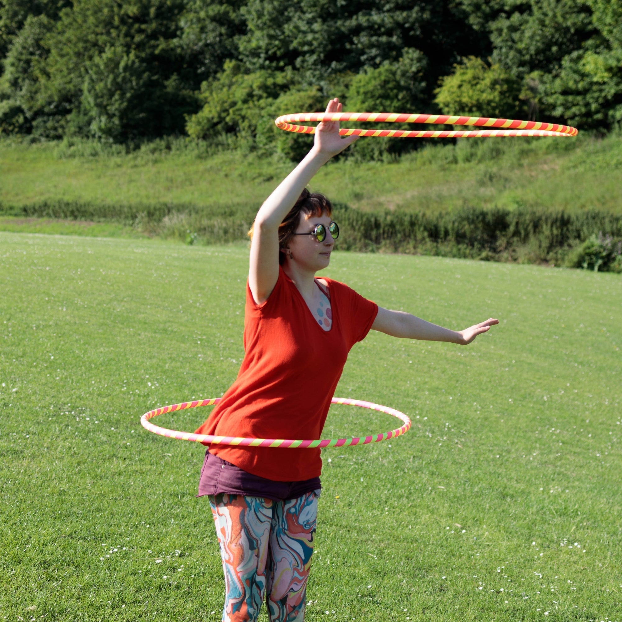person spinning two hoops