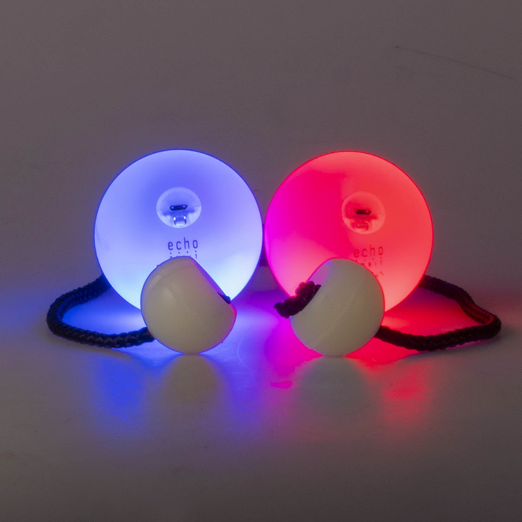 LED poi glowing, one blue, one red