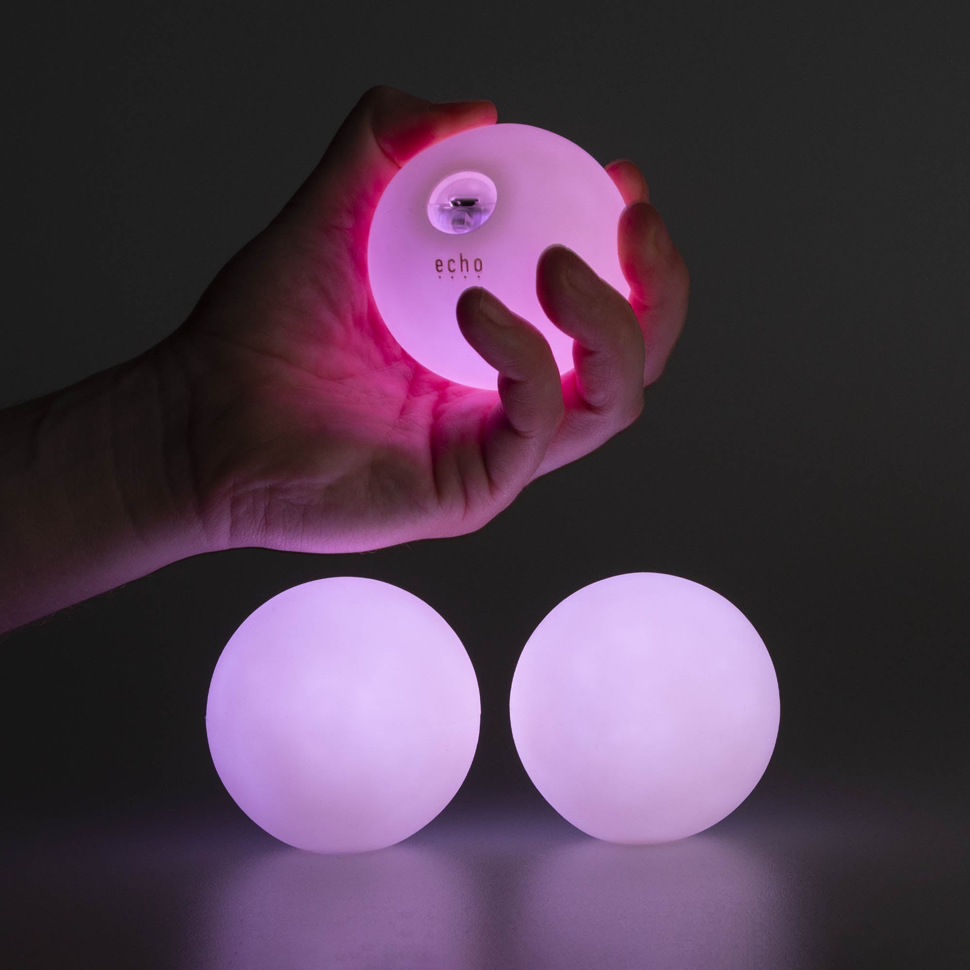 3 balls glowing with one being held