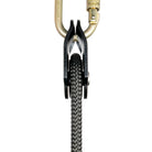 Petzl rescue pulley in black attached to carabiner