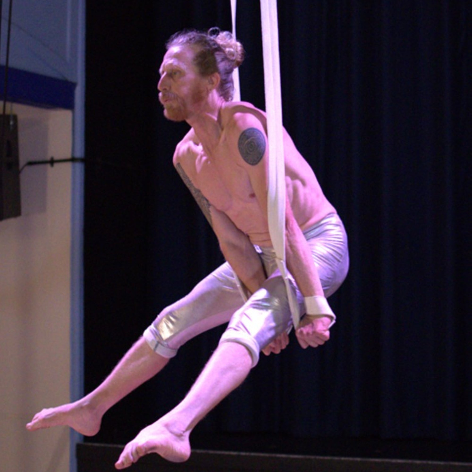 performer using cotton covered aerial straps
