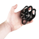 Hand holding a black pulley system against a white background