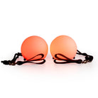 Spinballs glow poi glowing orange with a light background