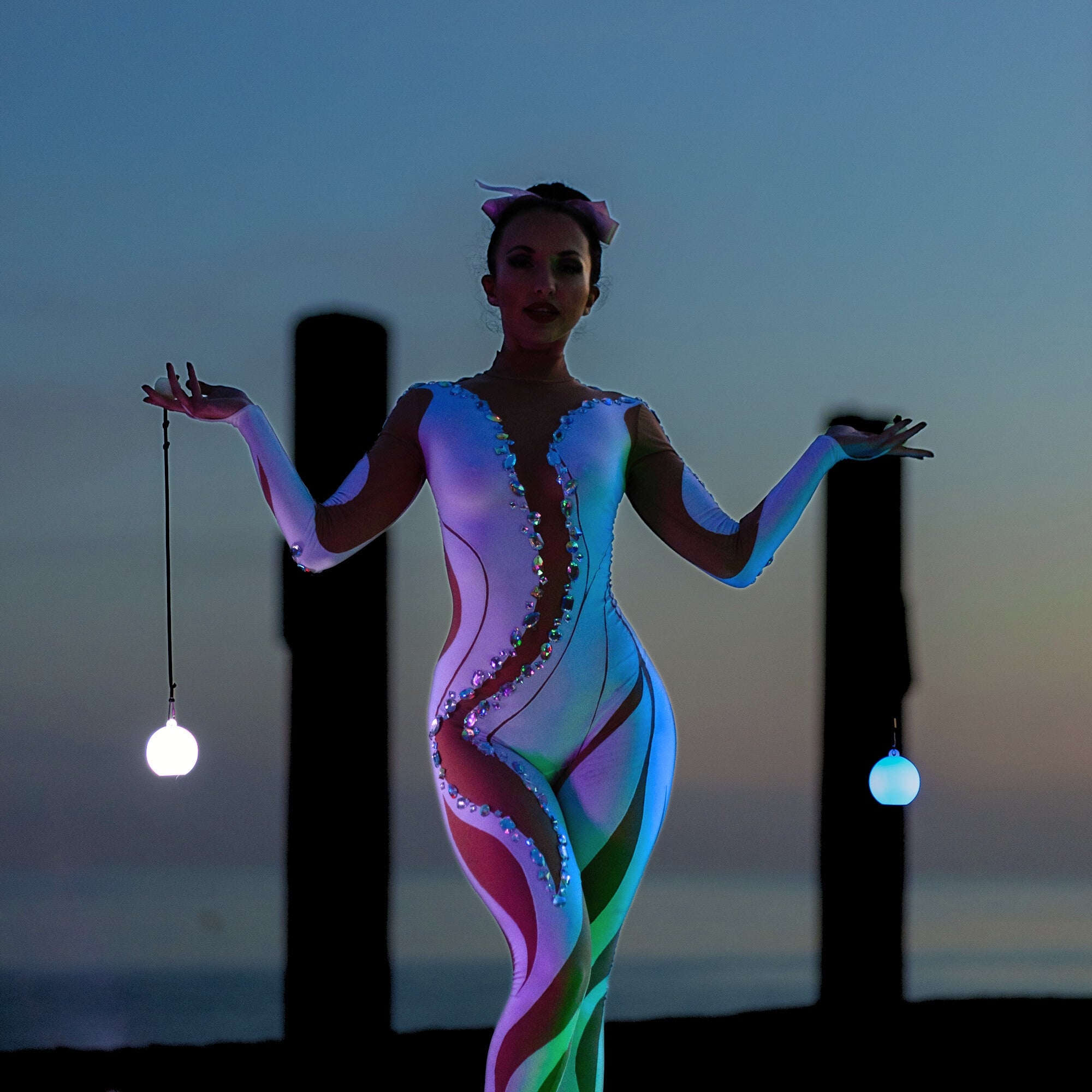 performer illuminated by glow poi
