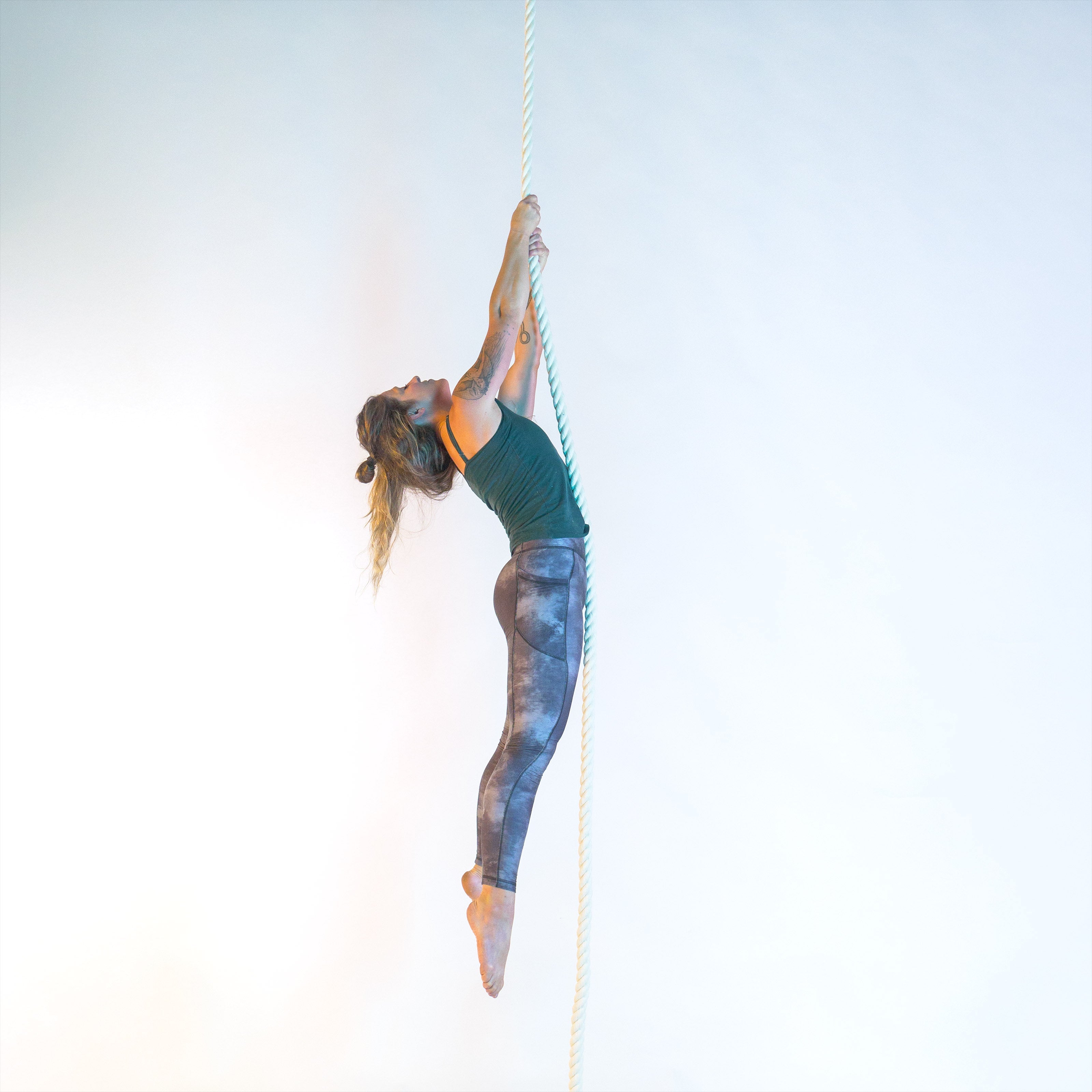 image of a dead-hang being performed on a rope