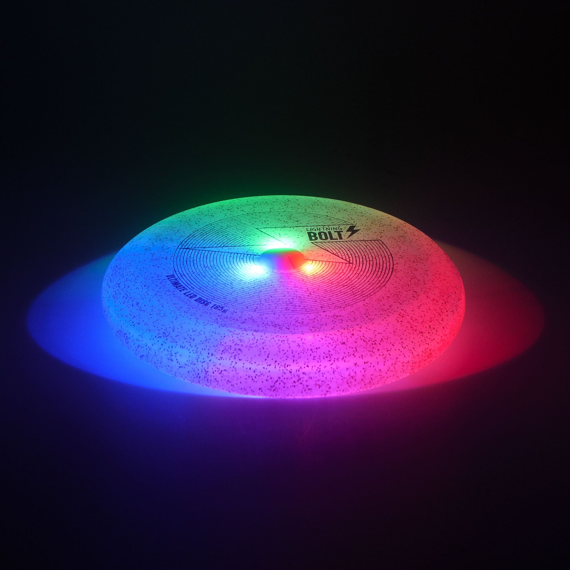 lighting bolt disc glowing red, blue and green on black background
